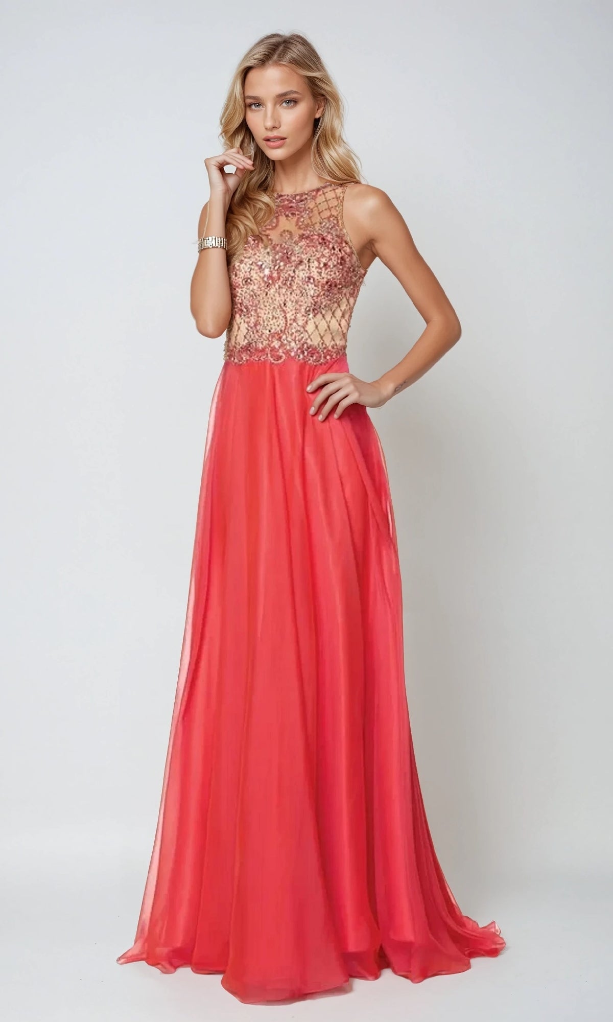 A woman in the Juliet 637 long prom dressโsleeveless, floor-length, red with a fitted embellished bodice and a sheer necklineโstands against a plain light background.